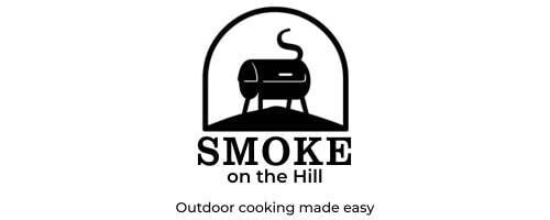 Logo for Smoke on the Hill featuring a barrel smoker inside an arched frame, with the text "SMOKE on the Hill" below and the tagline "Outdoor cooking made easy.