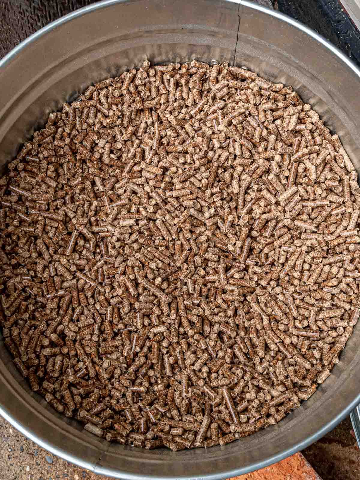 Large storage bin filled with wood pellets for smoking.