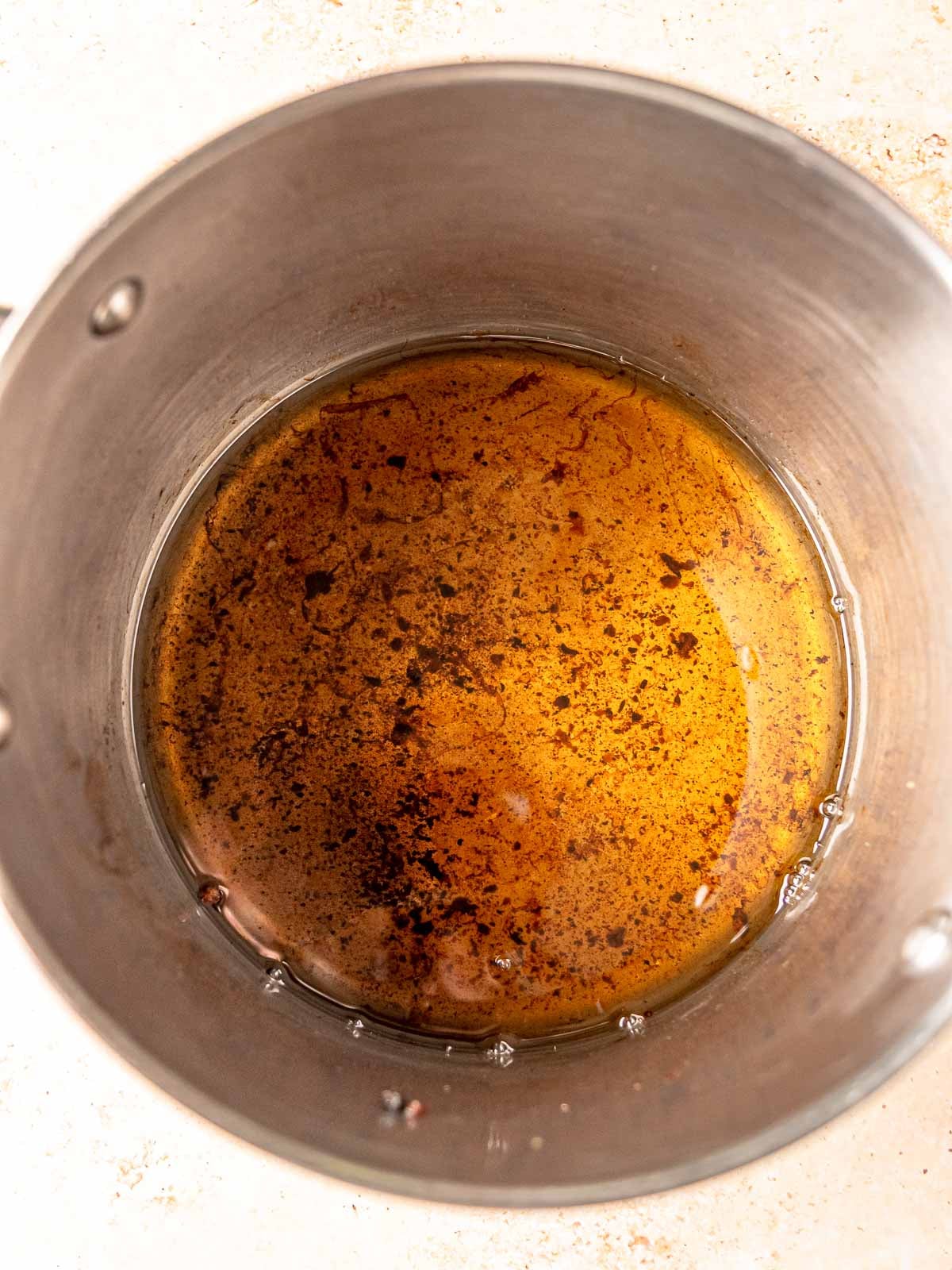 Hot beef tallow at the bottom of a pot.