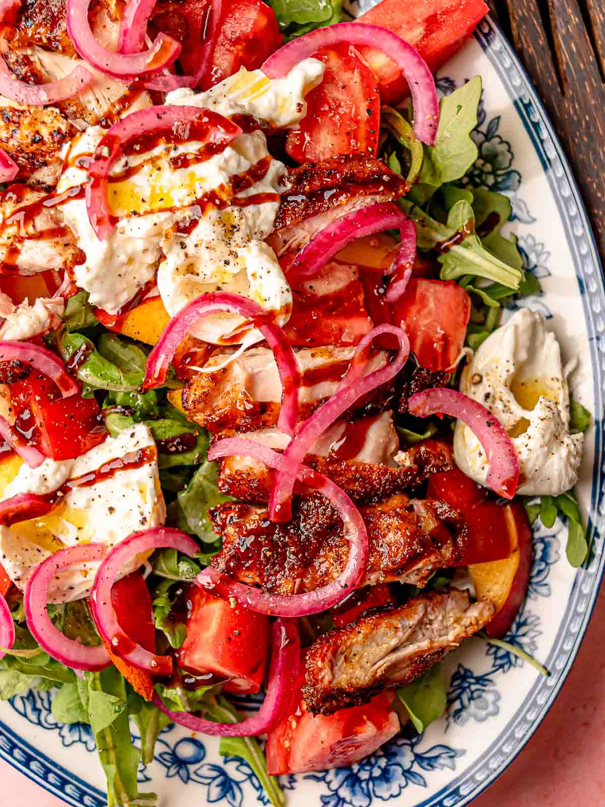 Smoked BBQ chicken salad topped with burrata, pickled red onions, and a drizzle of balsamic glaze.