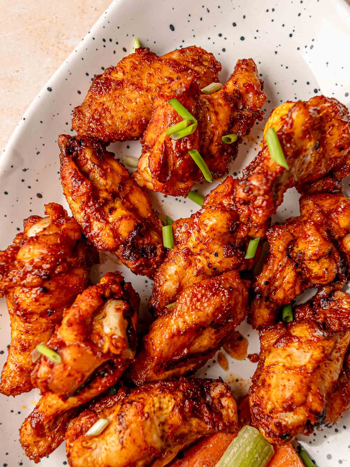 Sticky smoked honey ginger chicken wings with caramelized glaze and crisped edges.