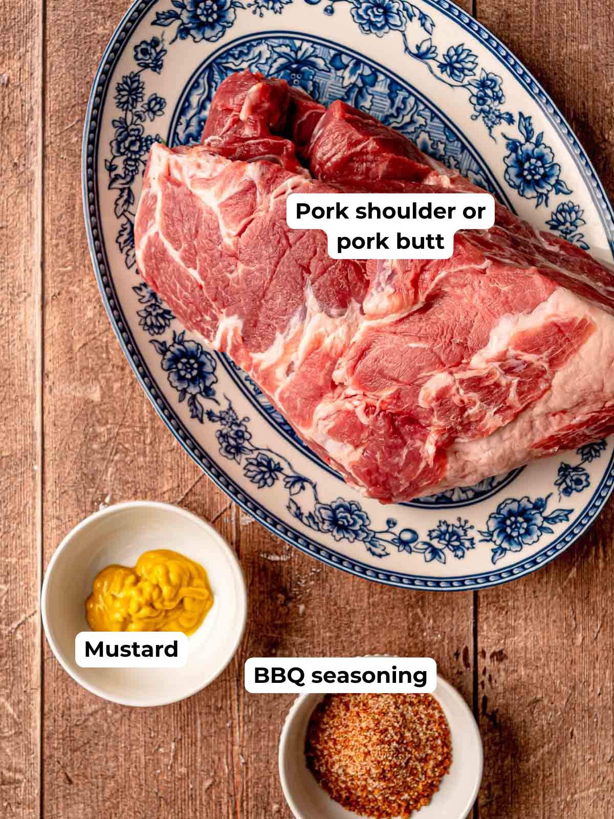 Pork shoulder with mustard and BBQ seasoning measured out on a cutting board.